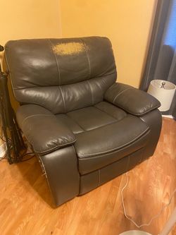 Black leather recliner chair with footrest