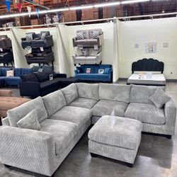 Gray corduroy sectional sofa with ottoman
