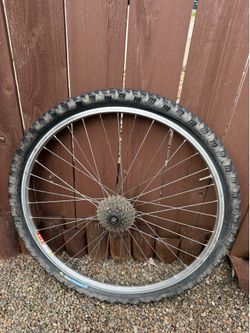 Selling a 26-inch rear bicycle wheel setup, perfect for a vintage mountain bike project or a budget replacement.
