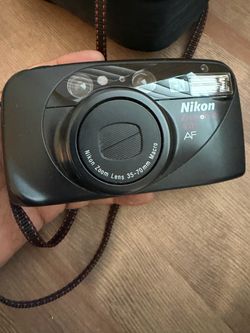 Vintage Nikon point and shoot film camera with the original case