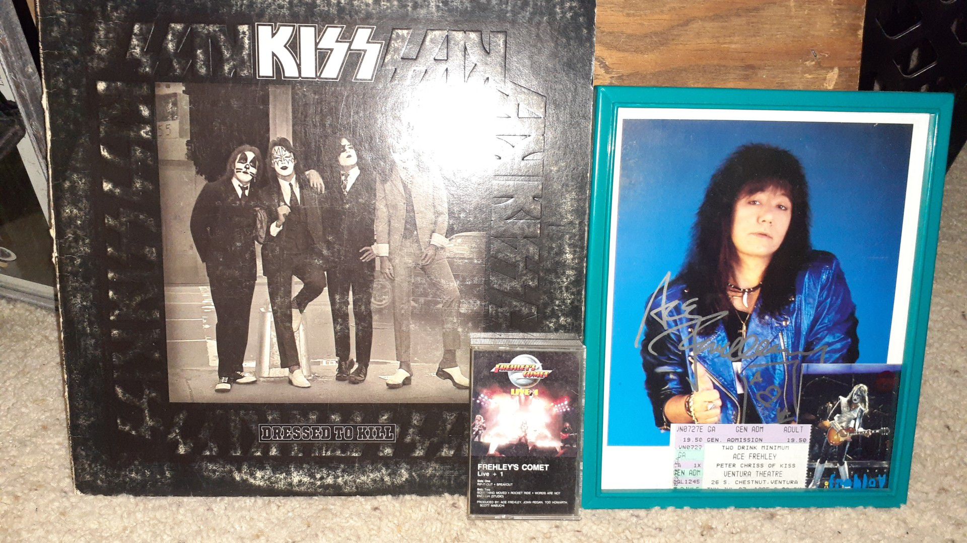 Kiss dressed to kill album and autographed ace frehley 8x10 colored photograph.