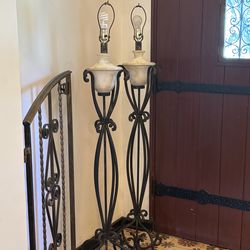 Pair of vintage wrought iron scrolled torchiere floor lamps with decorative ceramic urns