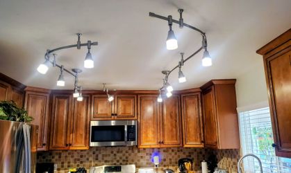 modern multi-head track lighting system (curved rails + multiple adjustable heads)