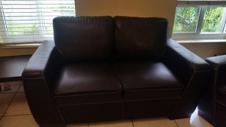 Black leather love seat couch and single couch