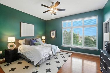 Grey upholstered Queen size bed with DreamCloud mattress and electric bed base