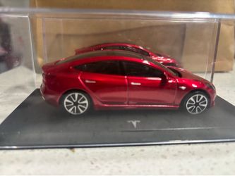 Red Tesla Model Car in Case
