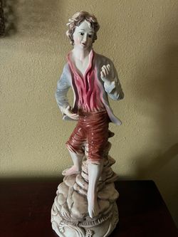 Pair of large Italian Capodimonte porcelain figurines depicting an 18th-century peasant boy and a girl carrying roses