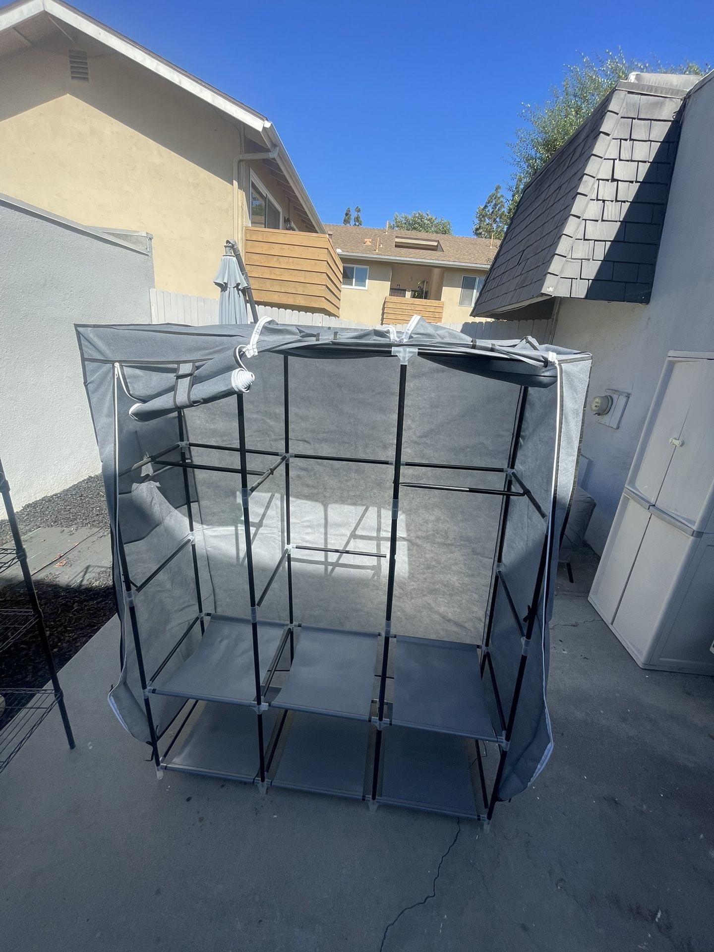 Portable closet organizer or a fabric wardrobe