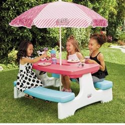 The LOL Surprise Birthday Party Table with Umbrella comfortably fits up to 6 kids