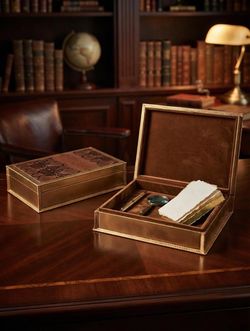 An Imitation snakeskin secret storage or book box brown with gold trim . Each $20, 2 for $35