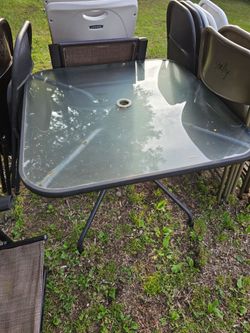 Square glass table with 4 foldable chairs