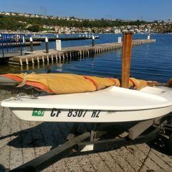 1978 Sailboat. 10' Mini Fish single hull Sunfish style and same manufacturer, Alcort. Hawke Boat Trailer is fully adjustable. $600
