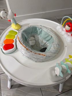 Baby jumper with activity center
