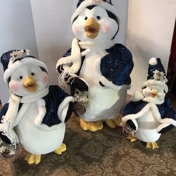 Set of three resin penguins.