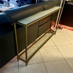 gold-framed, narrow console or sofa table Toned  Glass top and an Bottom glass shelf 