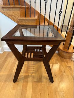 Contemporary table dark wood finish Four Beveled glass panes as a top Spacious lower slatted storage shelf