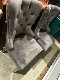 Four grey and silver dining chairs