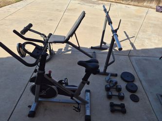 Workout Exercise. Bike, bench, Olympic bar, kettle and dumbbells, and weights.
