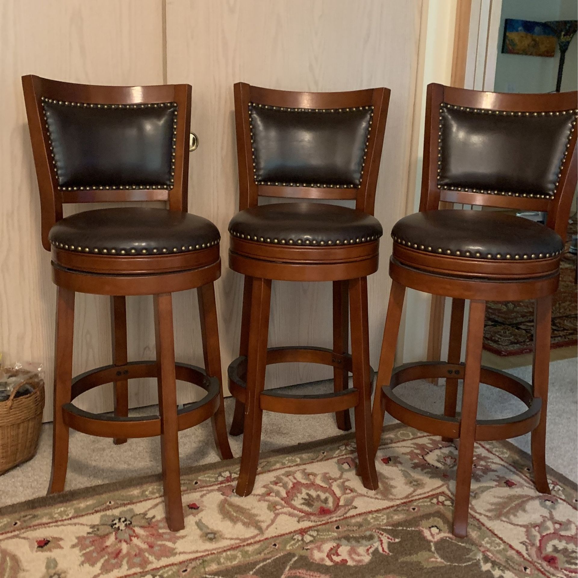 Swivel Bar Stools Black Leather+Cherry Wood+Brass Tacks . Floor to Seat 29”. Floor to top Of The Back 42”.