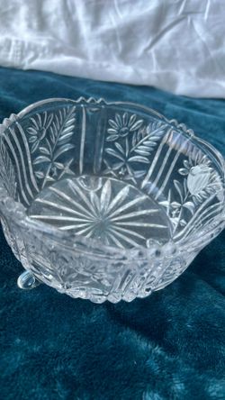 A vintage 24% lead crystal bowl with cut floral and starburst patterns.