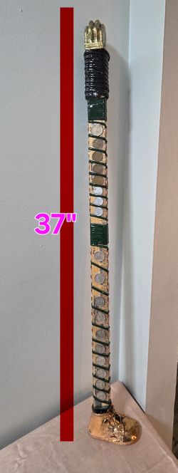 37" walking stick decorated with embedded coins and epoxy.