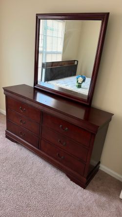 solid wood 6-drawer dresser with a matching framed  mirror