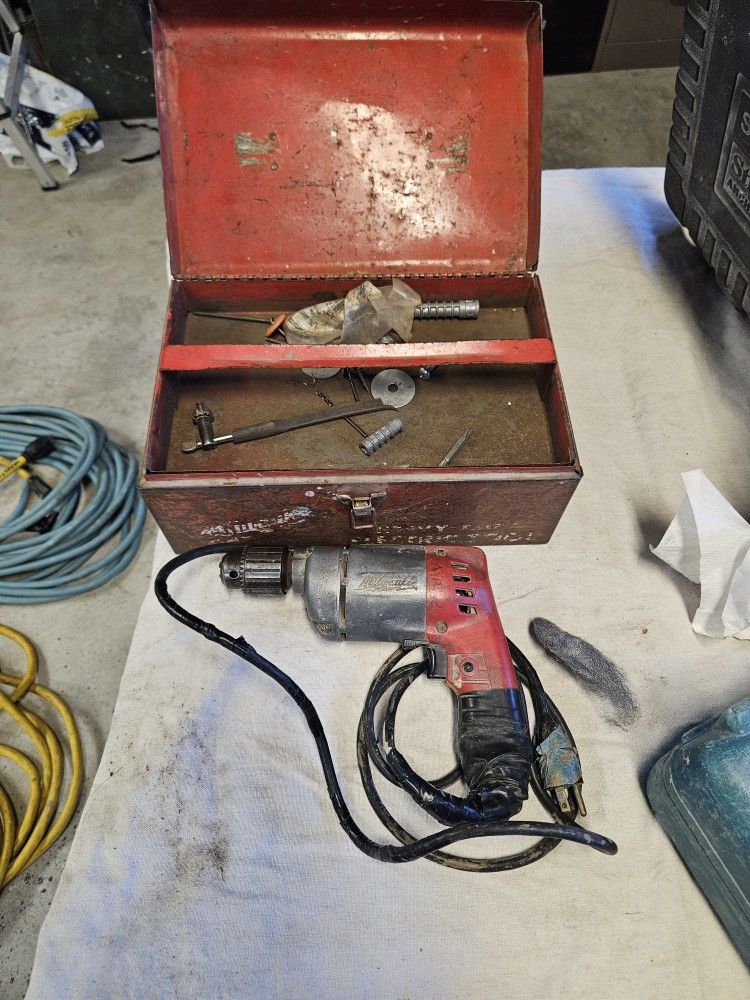 Milwaukee half inch Drill motor with box.