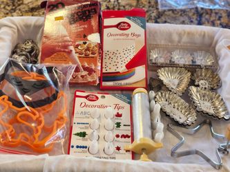 Miscellaneous cake decorating items. Decorating bags with tips, metal cake Decorator with tips, Halloween  cookie cutters, mini tart tins