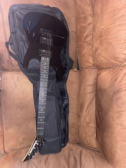 js11 dinky jackson guitar, leo jaymz scream-20 guitar amp, brand new guitar case, and a 10 foot cable