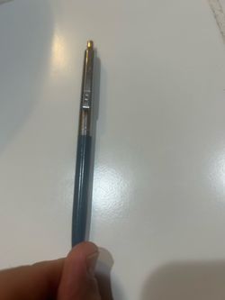 vintage Paper Mate Profile Double Heart Ballpoint Pen from the 1970s or 1980s, featuring a slim dark green or grey barrel, silver chrome trim, and the