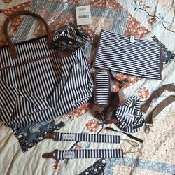 STACHRIS  Designer Baby Diaper Bag In Classic Black And White With Matching Changing Pad, Pacifier Pod, And Two Pacifier Clips
Has a small flaw handle