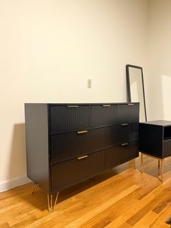 Like new black dresser and night stands with gold handles.