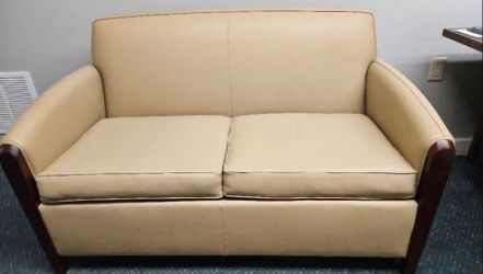 Tan Upholstered Loveseat with Wood Arm Accents