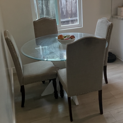 Round glass and white kitchen table with chairs