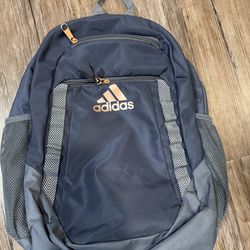 he backpack in the image is the adidas Excel Backpack Shadow Navy / Onix Grey / Rose Gold"m