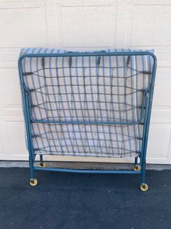 Used Portable folding bed with striped mattres