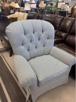 tufted armchair features a distinctive blue and white gingham check pattern