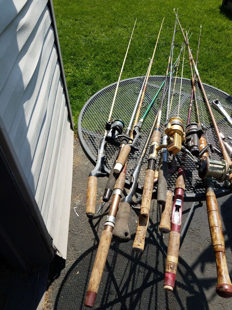 12 vintage fishing pole rods and 4 reels