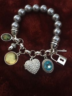 Avon 2008 Achievement award bracelet . Given for outstanding sales 8” 6 charms one is a locket