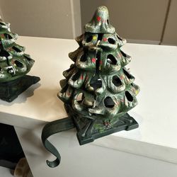Vintage cast-iron Christmas tree stocking hanger that also functions as a votive candle holder