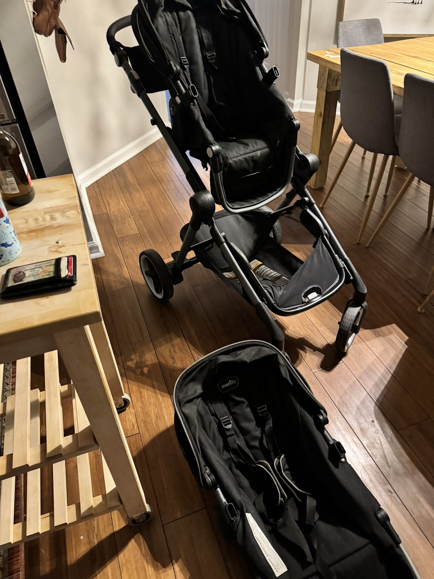 Evenflo double stroller with two seats and car seat insert with car seat base