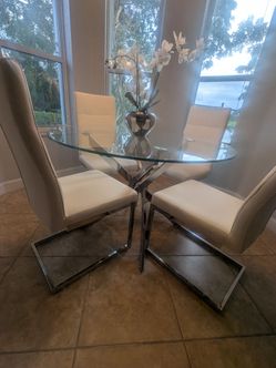 Glass dining table with four chairs