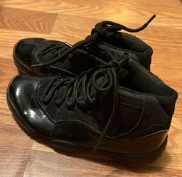 Black patent-leather youth/kids-style Jordan 11s.