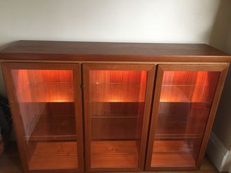 Solid wooden 3-door cabinet with adjustable glass shelves.