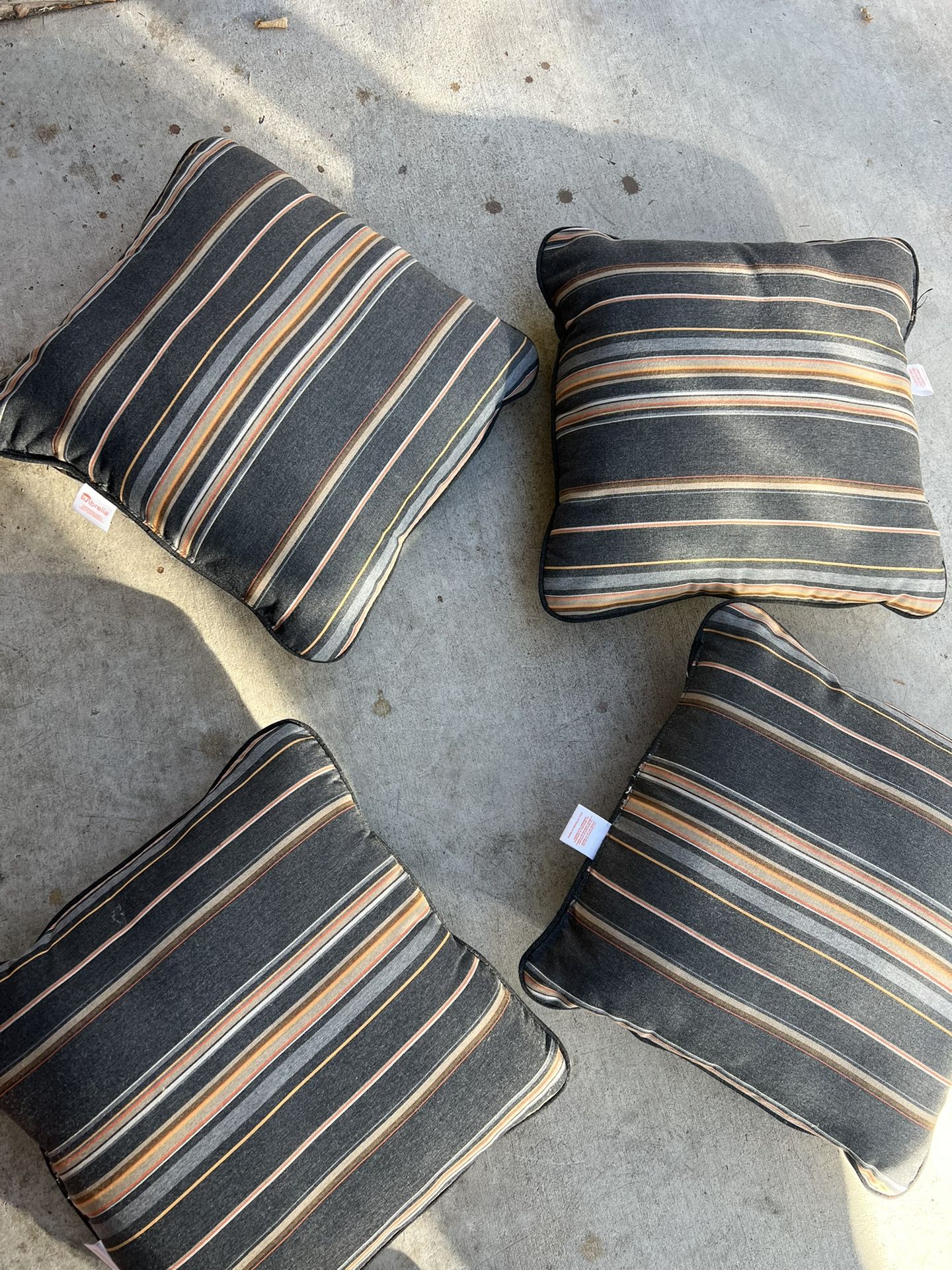 4 piece outdoor patio furniture cushions in gray/orange stripes (made by sunbrella)  Located in concord  Good condition  No damages/rips Measures 17” 