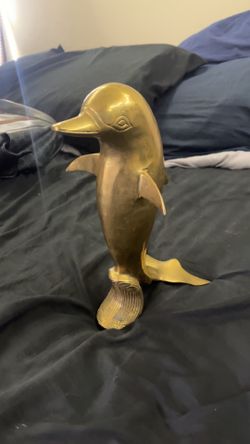 Antique brass dolphin sculpture