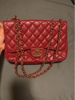 Authentic Chanel Classic Double Flap in red caviar leather with gold hardware.
