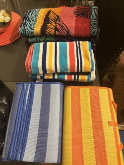 beach gear. towels, mats, umbrellas, and chairs