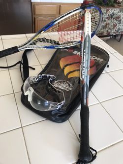 A pair of tennis ball rackets one para glasses one carrying case excellent condition