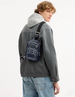 Coach Racer Sling Pack In Signature Canvas With Charms